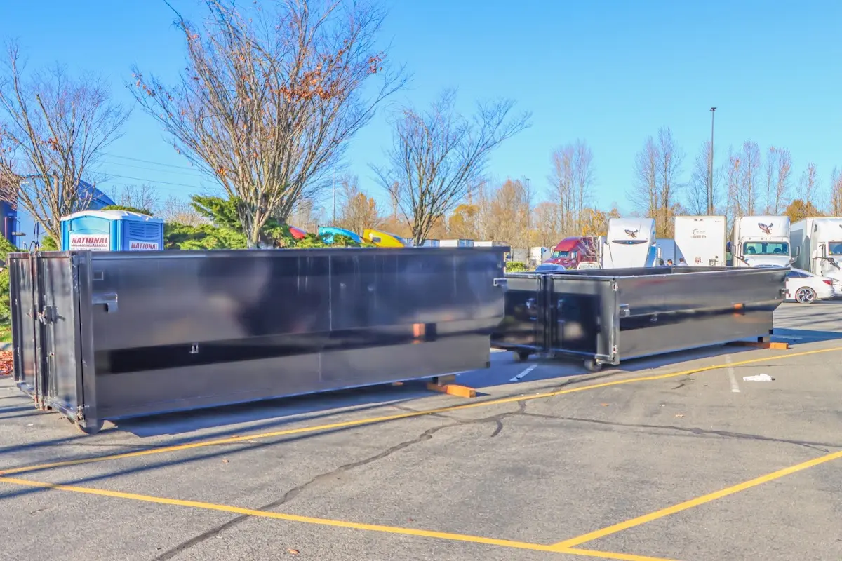 Professional dumpster rental service with roll-off container on residential driveway in Waco
